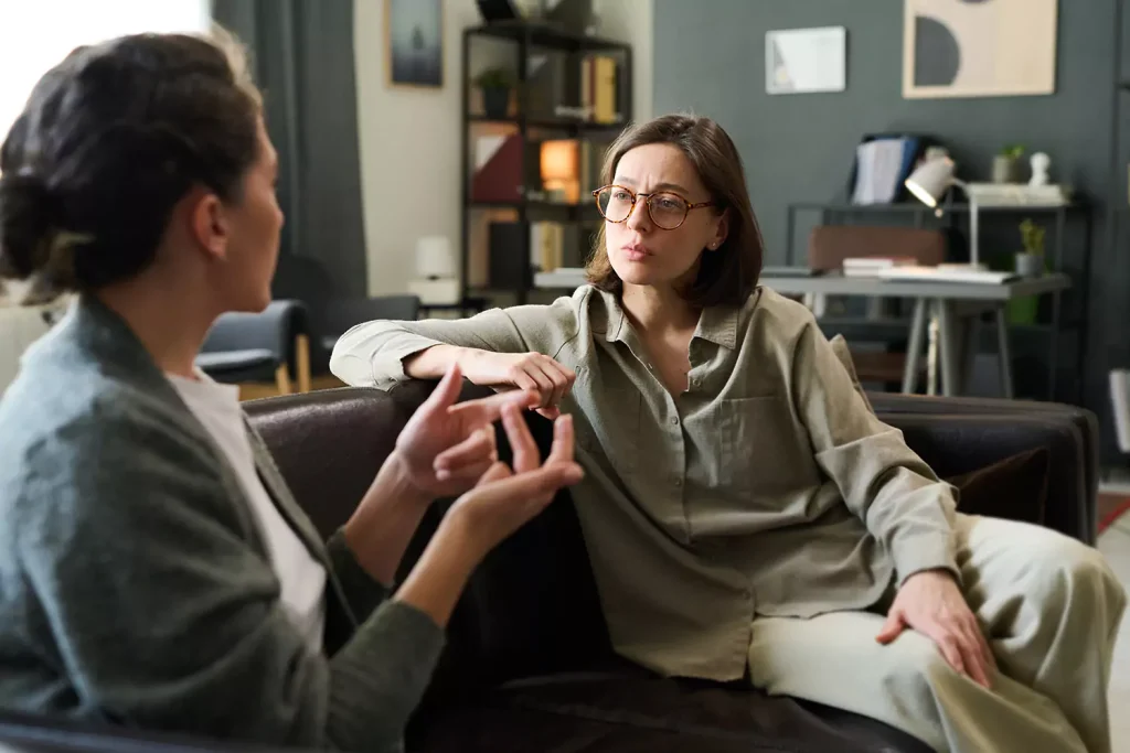 Counsellor sitting on couch talking with client